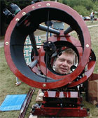 Phil harrington looking down the barrel of a Dobsonian reflecting telescope (32398 bytes)