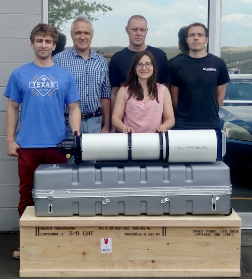 TEC's team, including Yuri, standing by an APO180FL telescope, case and packing crate (83,325 bytes)